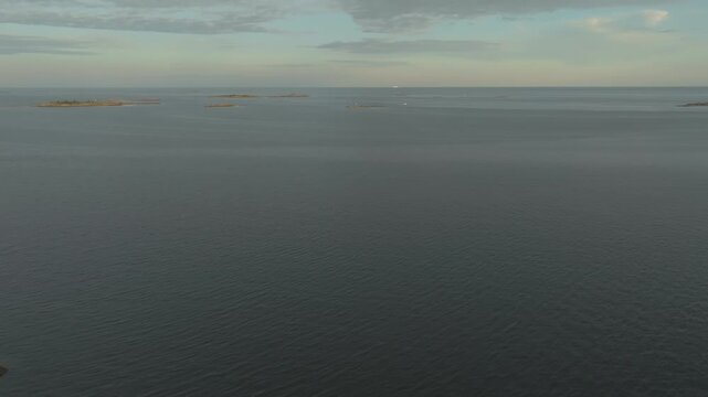 Aerial view approaching a motorboat cruising the Baltic Sea at sunset in Hanko