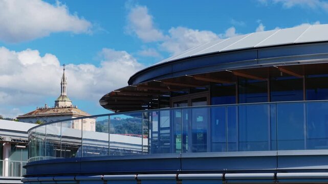 Close view of modern glass facade in Genoa revealed by smooth lateral drone pan