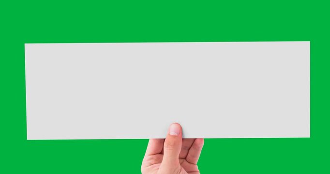 Hand holding a blank white placard with copy space against black background