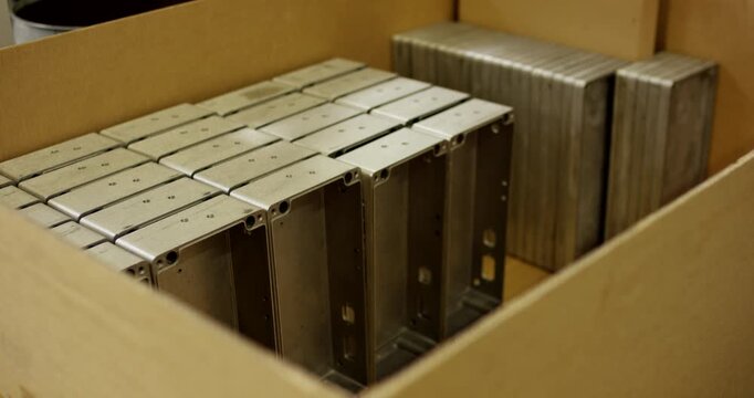 Aluminum industrial enclosures and metal housing components packed in a cardboard box for shipping