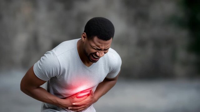 Healthcare awareness image of a man pressing both hands to his stomach with a strained expression, glowing red hotspot in the abdominal region symbolizing stomach ache, digestive d