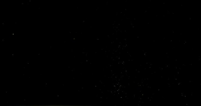 Super slow motion (1000 fps) floating dust particles in the air, isolated on black background. Cinematic atmospheric shot with soft light, depth and abstract texture.