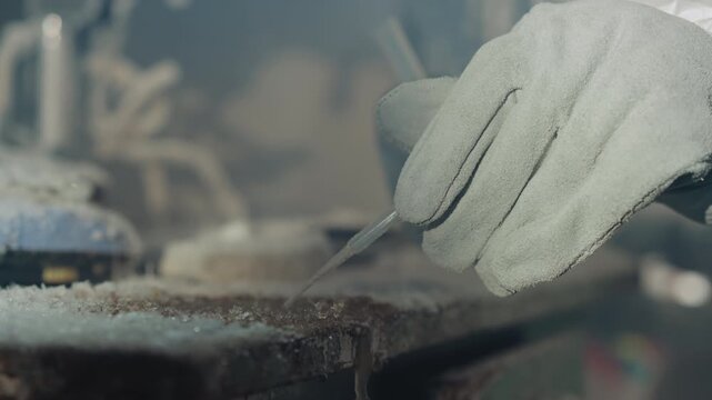 Gloved hand using tweezers to extract frozen vial on lab bench, technician in protective suit handling cryogenic residue, sterile yet decayed environment, winter light and vapor, careful forensic