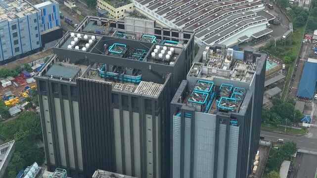 Aerial view circling over the rooftop of a modern data center building, showing its advanced cooling system and hvac units in jakarta