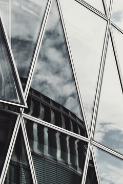 Glass facade reflection in abstract geometry with modern urban architecture building lines creating a crisp minimal surface