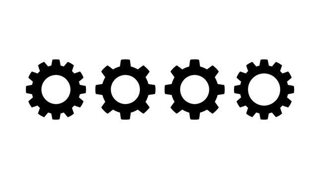 Four black gear wheels in a row representing industrial machinery, engineering, and automation concepts