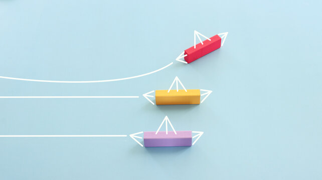 Concept image of wooden cube and boat metaphor. Idea of leadership and education