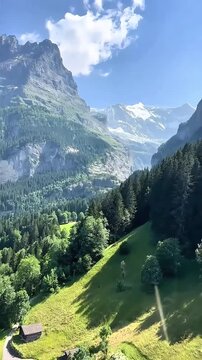 aerial view of swiss alps mountain landscape in grindelwald valley with green meadow