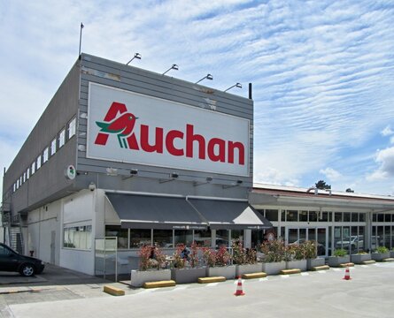 Auchan hypermarket building featuring cafe frontage and parking