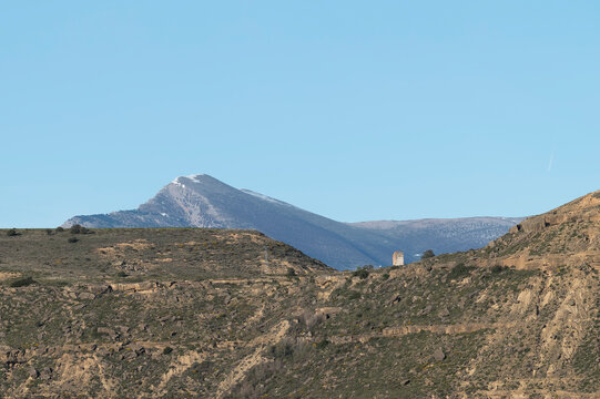 Majestic view of Tozal de Guara peak in the Sierra de Guara Natural Park, Huesca, Spain, rocky limestone mountain landscape under a clear blue sky.
