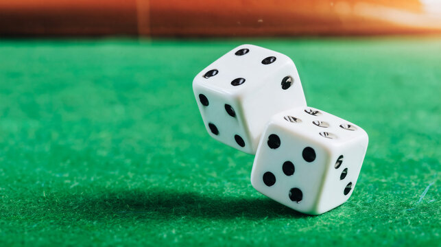 Pair of white dice rolling on a green casino table with copy space.