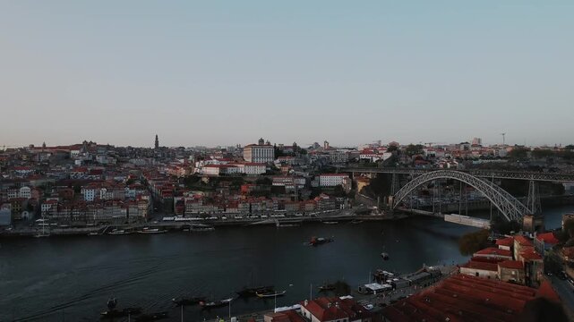 Dom Luis I Bridge and Douro River in Porto municipality Porto district Norte region Portugal with boats river traffic and metro line crossing between Porto and Vila Nova de Gaia, lateral pan right dro