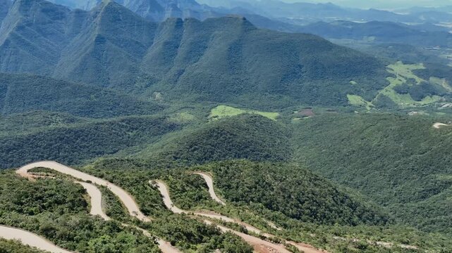 Mountain switchbacks aerial view on steep forested slopes at Serra da Rocinha in southern Brazil.