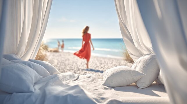 Woman in Red Dress Walking on Beach Seen From Bed with White Curtains and Bedding