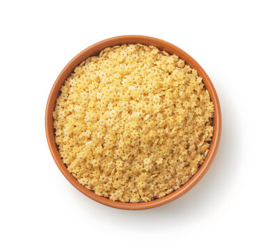 Uncooked stelline pasta in clay bowl