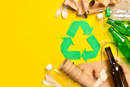 Symbol of recycling. The concept of fighting plastic and pollution of the planet. On a yellow studio background.