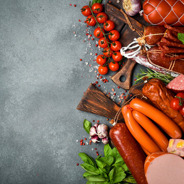 Set of different types of sausages, salami and pepperoni on the table. Top view.