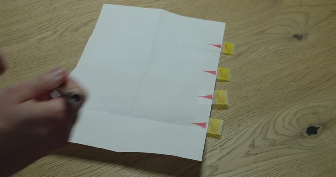 Paper document with marked signature areas using sticky tabs and a pen. Concept of contract signing, legal agreement, and document preparation.
