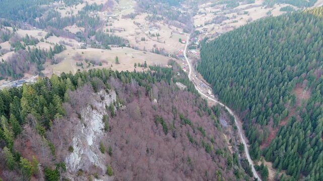 Aerial View of Winding Road in Carpathian Mountain Valley with Rocky Slopes