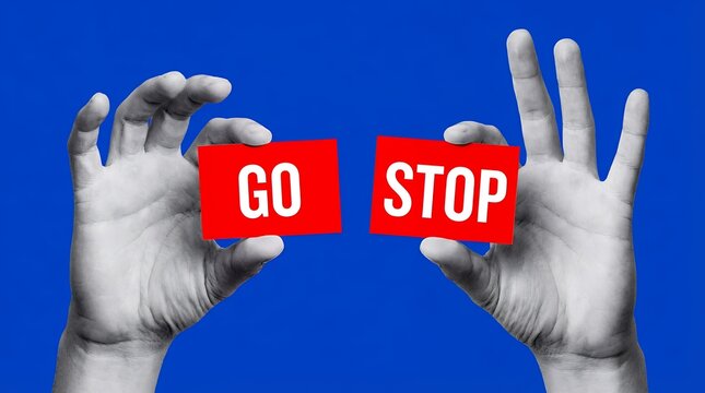 Two hands hold red cards with white text saying GO and STOP emphasizing a choice between movement and cessation against a blue backdrop decision word holding separation contrast