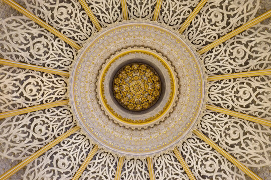 Ornate circular ceiling rosette with gold detail