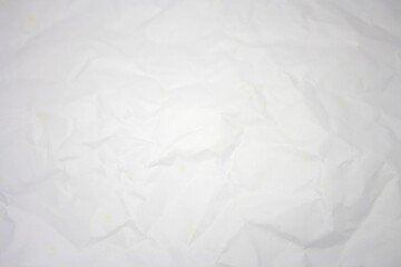 Fototapeta premium Top view of wrinkled white paper surface with copy space