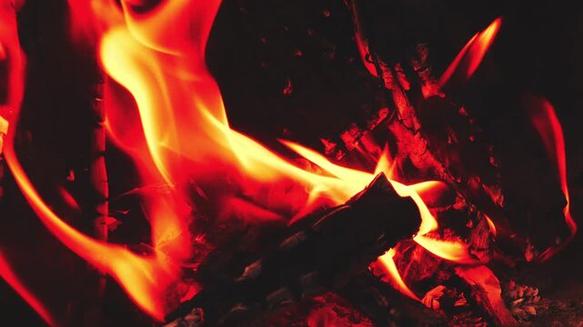 A bright bonfire of logs burns fiercely.