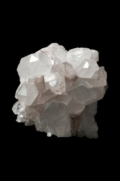 Natural clear quartz crystal cluster isolated on black background, raw mineral macro close up