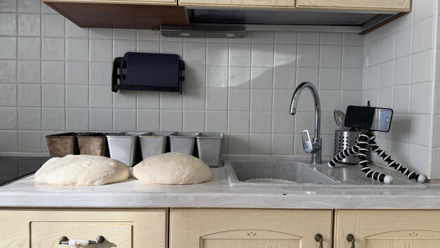Fresh sourdough dough balls on kitchen counter, illustrating bread baking and recipe preparation.
