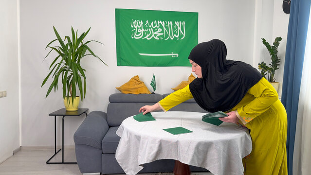 Saudi Arabia woman arranging table for Ramadan Iftar