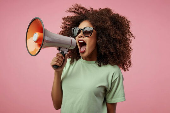 excited young african american woman with curly hair, holding a megaphone and screaming,Promotion, action, holiday, ad, job questions. Vacancy. Business discount concept, communication, information