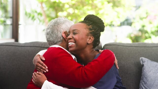 Joyful Moment: Caregiver and Senior Woman Share a Warm Embrace and Laughter