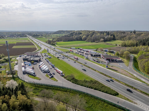 Aerial view of highway rest stop with truck parking and gas station in Rotselaar, Belgium