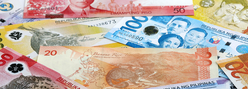 Philippine peso money banknotes pile on table. Philippines bills of PHP currency close up