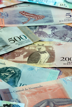 Venezuelan bolivar money banknotes pile on table. Venezuela bills of VES currency close up