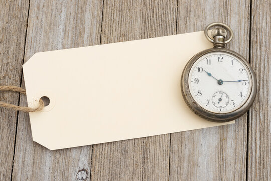 Blank cream tag with vintage pocket watch