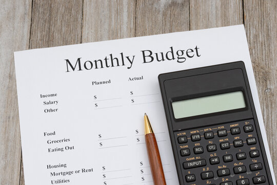 Monthly budget with calculator and pen