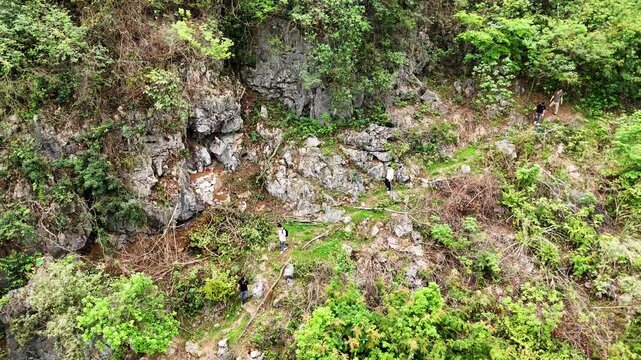 Aerial View of Hardcore Tomb Sweeping in Guangxi, People Climbing Steep Karst Hill for Ancestral Rituals