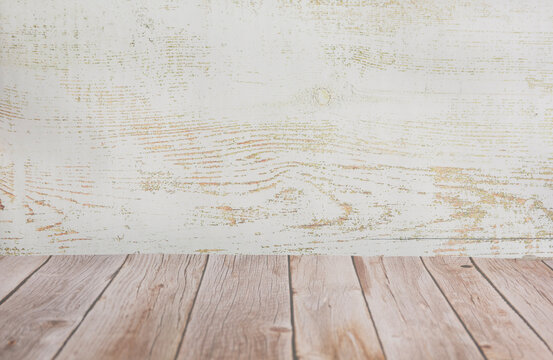 Empty wooden table top with white rustic wood wall background.