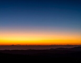 Obraz premium Scenic Sunset Over Hills Landscape with Gradient Sky in Golden Hour