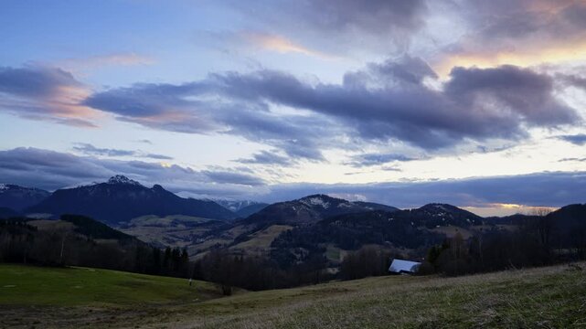 Sunset mountain landscape with dramatic moving clouds time lapse