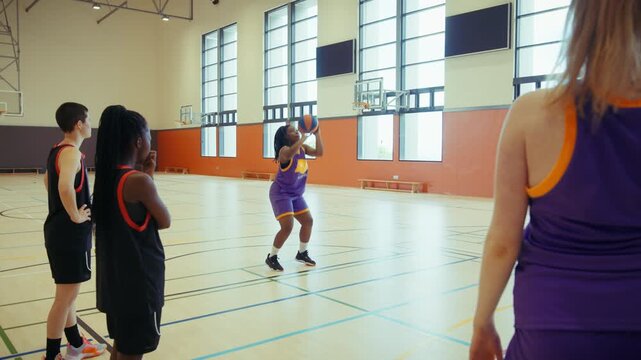 Young women practice basketball drills