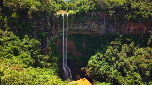 Aerial view of Chamarel Waterfall in Mauritius, lush tropical jungle and high rocky cliffs