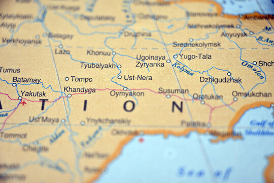 Ust Nera Location on World Map Photograph with Soft Blur Background and Defocused Atlas Detail
