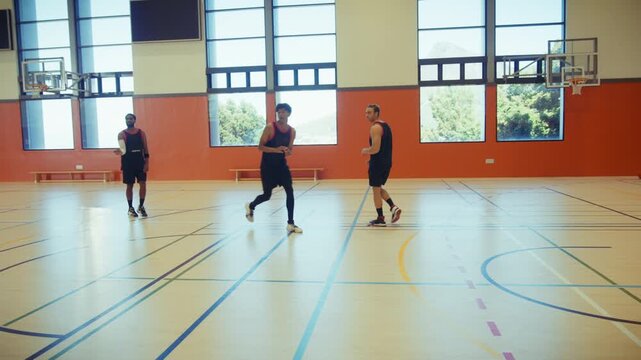 Active men playing basketball together