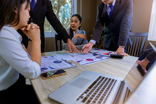 Business peoples meeting to discuss the situation on business plan, marketing for investment. Selected focus