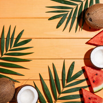 AI generated. Slices of watermelon and coconuts , on a orange background. Summer background.