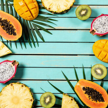 Slices of tropical fruit, on a Turquoise background. Summer background.