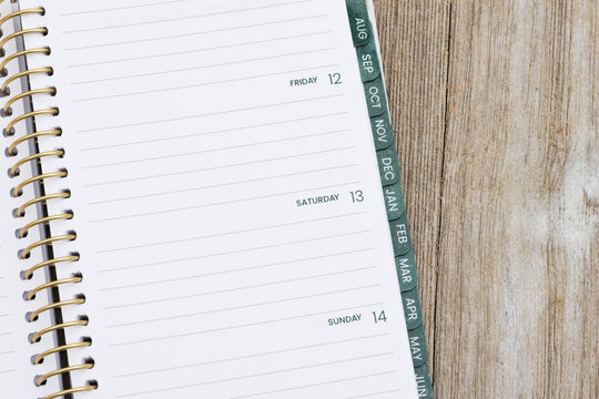 Open day planner notebook on rustic wood desk