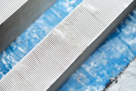 Close up of white aerated concrete blocks with ribbed texture for construction and building materials. Building regulations and quality control cement shape making.
